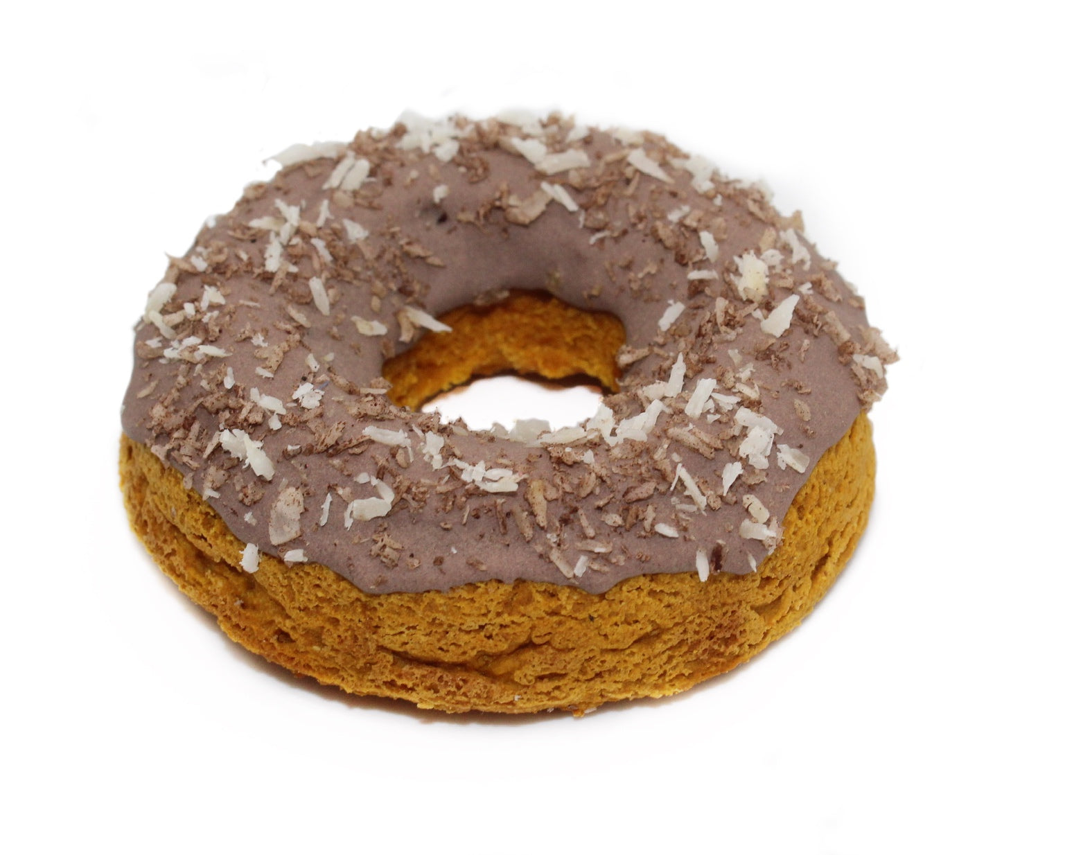 A brown, carob frosted pumpkin donut with plain and carob coconut flakes on top.