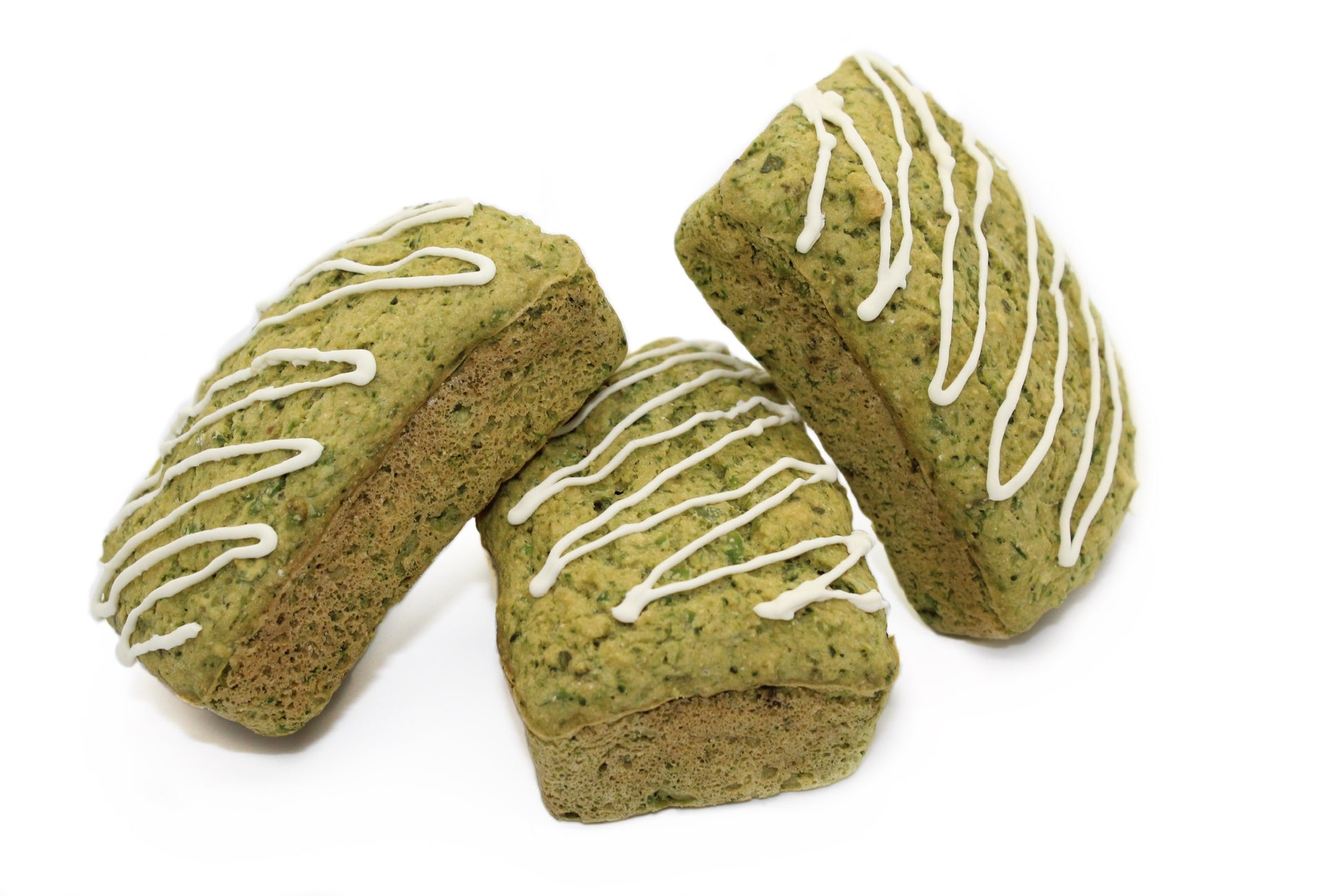 Three green Broccoli and peas loaves with white drizzle frosting.